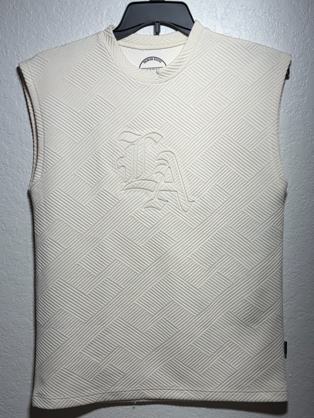 Cream Textured Sleeveless Top with Embossed LA Monogram